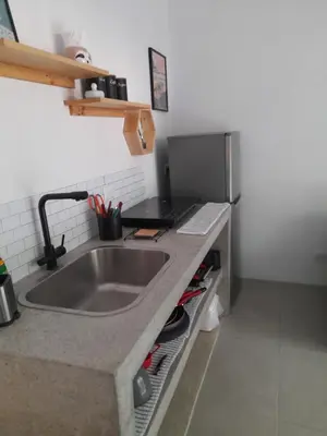 a kitchen with a sink and a laptop on a counter at Moon Home Sun #3 in Playa hermosa
