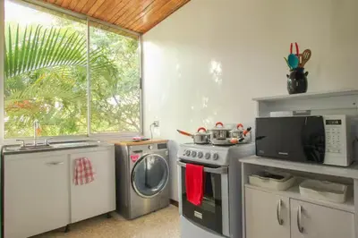 a kitchen with a washing machine and a microwave at Bright and central apartment near Plaza del Sol in Guayabos