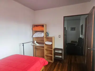 a bedroom with a bed and a room with a mirror at Bright and central apartment near Plaza del Sol in Guayabos