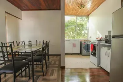 a dining room with a table and chairs in a kitchen at Bright and central apartment near Plaza del Sol in Guayabos