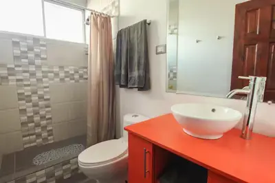 a bathroom with a white sink and a toilet at Bright and central apartment near Plaza del Sol in Guayabos