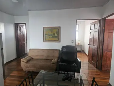 a living room with a couch and a chair at Bright and central apartment near Plaza del Sol in Guayabos