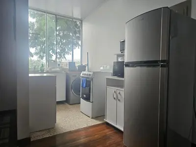 a kitchen with a refrigerator and a washing machine at Bright and central apartment near Plaza del Sol in Guayabos