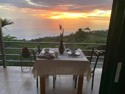 a table with a vase on it with a view of the ocean at Villa Del Mar 3 Spectacular ocean view in Savegre