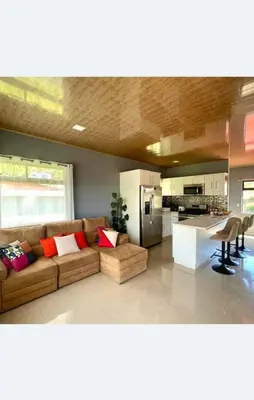 a living room with a couch and a kitchen at Apartamento Marina in Monteverde Costa Rica
