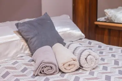 a pile of towels sitting on top of a bed at Apartamento Marina in Monteverde Costa Rica