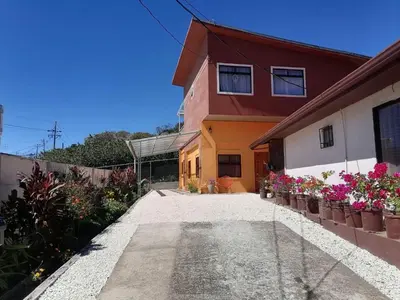 a house with flowers on the side of it at Apartamento Marina in Monteverde Costa Rica