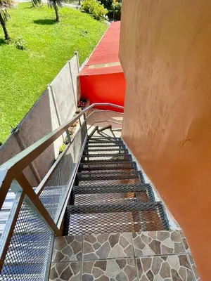 a set of stairs with two benches next to a building at Apartamento Marina in Monteverde Costa Rica