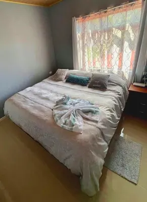 a bedroom with a large bed with a window at Apartamento Marina in Monteverde Costa Rica