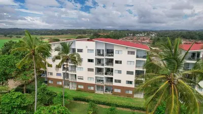 an aerial view of a building with palm trees at Beautiful beachfront condo, amazing pool in Bejuco