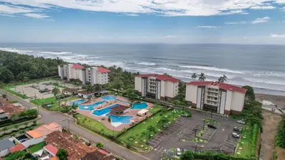 an aerial view of a resort near the ocean at Beautiful beachfront condo, amazing pool in Bejuco