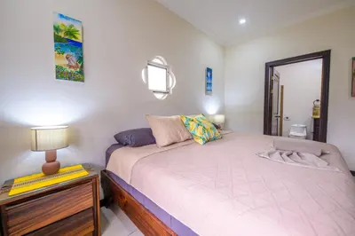 a small bedroom with a bed and a lamp at Villa Sirena Del Mar by Vacation Pura Vida in Bejuco