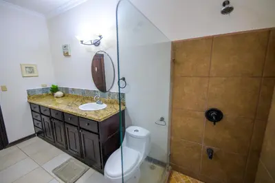 a bathroom with a toilet and a sink and a shower at Villa Sirena Del Mar by Vacation Pura Vida in Bejuco