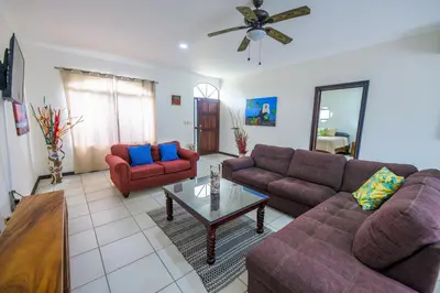 a living room with two couches and a coffee table at Villa Sirena Del Mar by Vacation Pura Vida in Bejuco