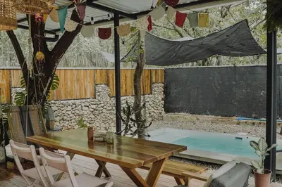 a patio with a table and a bath tub at La VanDida, Camper house in Paraíso