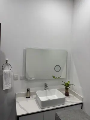 a white bathroom with a sink and a mirror at Verde Armonía Lodge in Naranjito