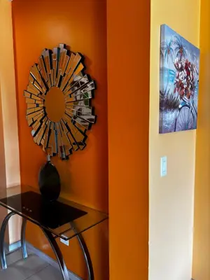 a room with a table and a fan on a wall at Primium Jaco Bay in Jacó