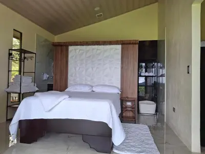 a bedroom with a large white bed with a canopy at Casita El Perezoso in San Rafael