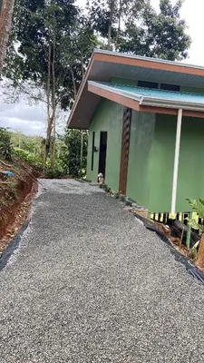 a house with a gravel driveway next to a building at Casita El Perezoso in San Rafael