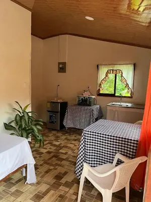 a room with two tables and a window at Villa Rancho Caballito in Nicoya
