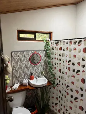 a bathroom with a toilet and a sink in it at Villa Rancho Caballito in Nicoya