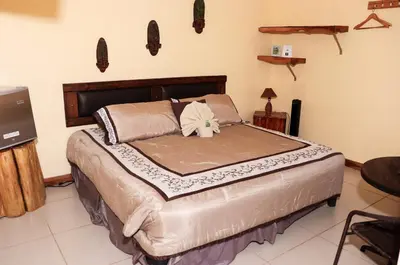 a large bed in a room with at Hotel Orocay Lodge in Cartago