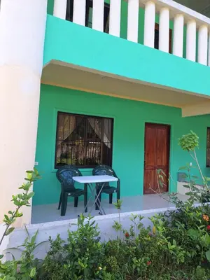 a green house with two chairs and a table at La Tica in Horquetas