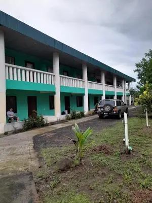 a truck parked in front of a building at La-Tica in Horquetas