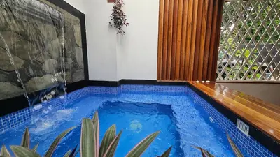 a swimming pool in the middle of a house at The Hideaway La Fortuna in Fortuna