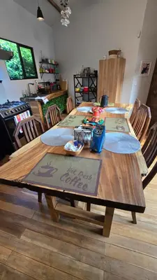 a wooden table with chairs in a living room at Bahia Ballena Walk to the Beach Uvita Apartments in Uvita