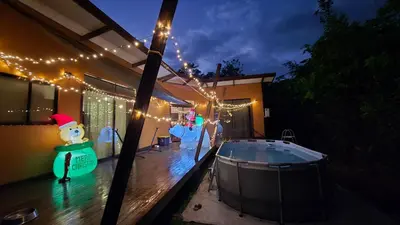 a backyard with a hot tub and christmas lights at Bahia Ballena Walk to the Beach Uvita Apartments in Uvita