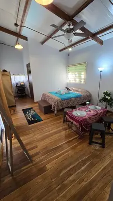 a room with a bed and a table in it at Bahia Ballena Walk to the Beach Uvita Apartments in Uvita