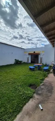 a building with a picnic table in the grass at Hostal Zurgab in San Vicente