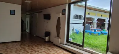 an empty room with a large window and a yard at Hostal Zurgab in San Vicente