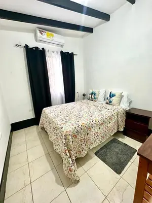 a bedroom with a bed with a blanket on it at Apartamento Chazu #3 in Quepos