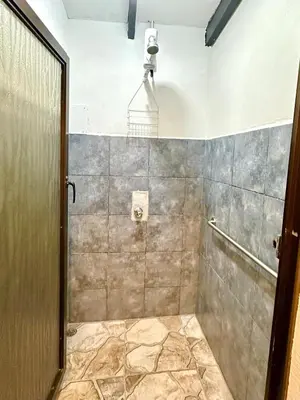 a bathroom with a shower with a camera on the wall at Apartamento Chazu #3 in Quepos