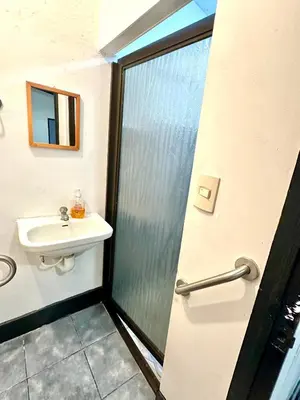 a bathroom with a shower and a sink at Apartamento Chazu #3 in Quepos