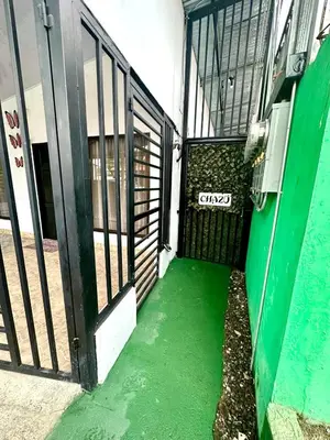 an entrance to a building with green floors and a door at Cabina Chazu#1 in Quepos