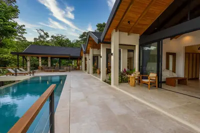 an external view of a house with a swimming pool at Bahia Rooms in Mal País