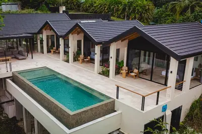 an aerial view of a house with a swimming pool at Bahia Rooms in Mal País
