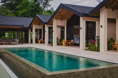 a swimming pool in front of a house at Bahia Rooms in Mal País