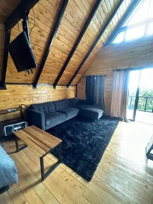a living room with a couch and a table at Cabaña La Trinidad de Dota in El Copey