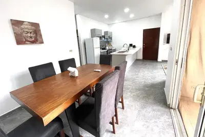 a dining room with a wooden table and chairs at Villas Portofino in Tamarindo