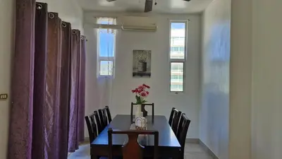 a dining room with a table and purple curtains at Villas Portofino in Tamarindo