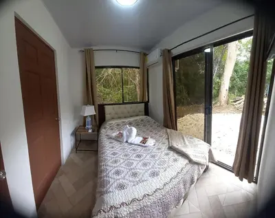 a bedroom with a teddy bear laying on a bed at Villa Fortuna in San José Pinilla