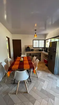 a kitchen with a table with chairs and a refrigerator at Villa Fortuna in San José Pinilla