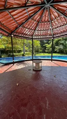 a pavilion with a table in the middle of a patio at Villa Fortuna in San José Pinilla