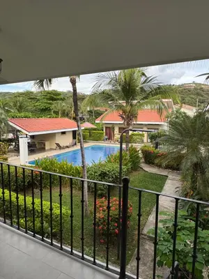 a view of the pool from the balcony of a resort at Casa Rosa del Mar in Coco