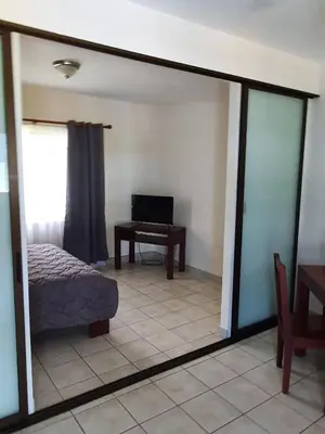 a mirror in a room with a bed and a desk at Marina Loft Condos 212 in Coco