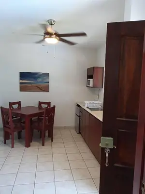 a kitchen and dining room with a table and a ceiling fan at Marina Loft Condos 212 in Coco